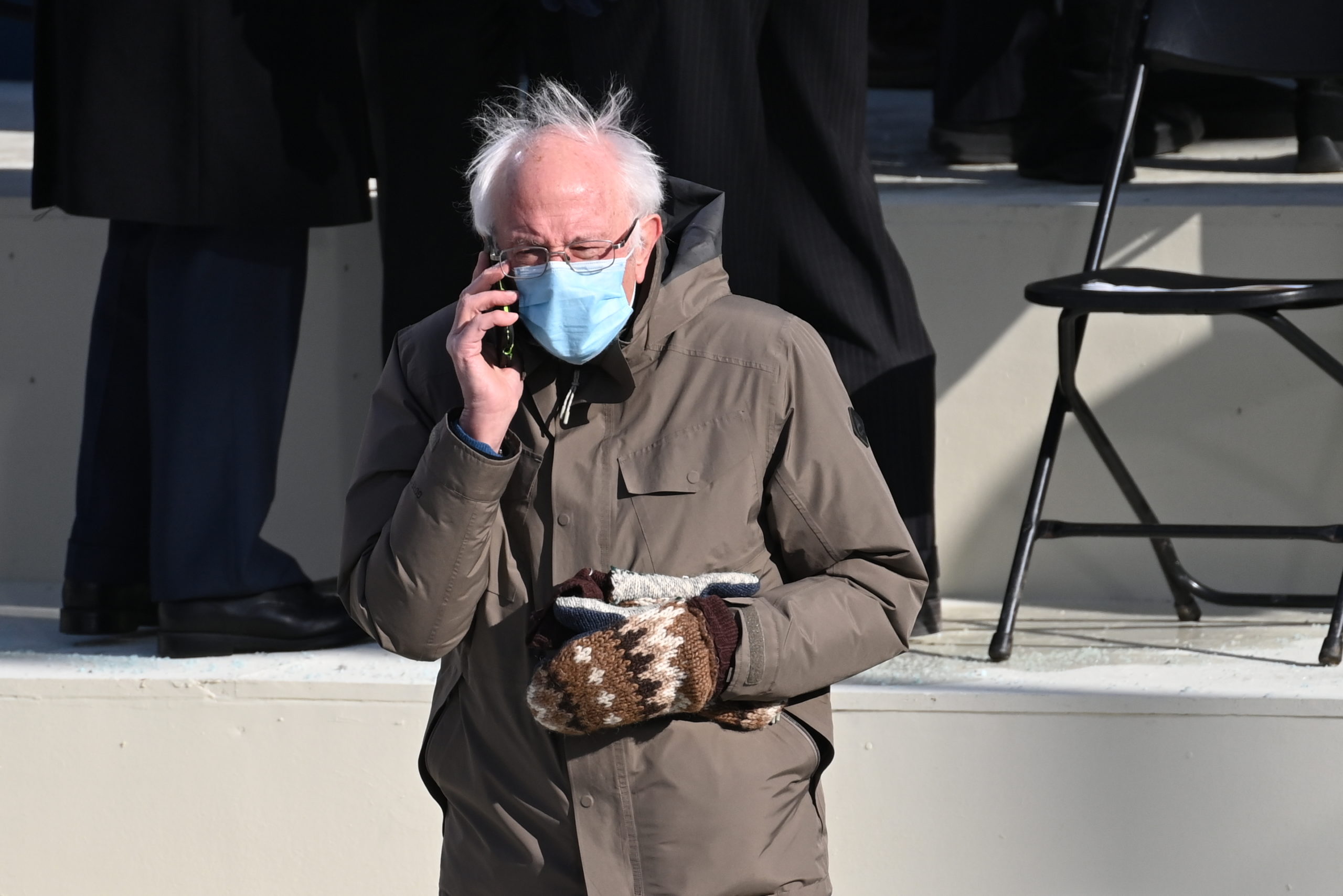 Senator Bernie Sanders, a Democrat from Vermont, speaks on a mobile phone while arriving for the 59th presidential inauguration in Washington, D.C., U.S., on Wednesday, Jan. 20, 2021. Biden will propose a broad immigration overhaul on his first day as president, including a shortened pathway to U.S. citizenship for undocumented migrants - a complete reversal from Donald Trump's immigration restrictions and crackdowns, but one that faces major roadblocks in Congress. Photographer: Saul Loeb/AFP/Bloomberg via Getty Images